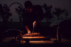 Catering Chef slicing Prime Rib in a Dim setting