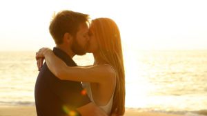 Couple kissing during sunset on the beach