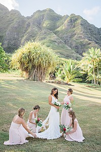 bridesmaids holding the brides dress