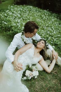 wedding couple laying in the grass