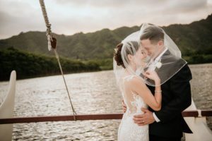 bride and groom on a boat in hawaii