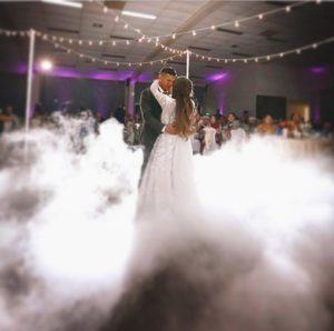 couple dancing at wedding in smoke