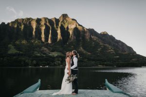 couple kissing on boat at kualoa
