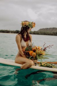 Girl on a Surfboard with Flower Bouquet