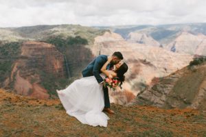 Couple Kissing on top of Mountain