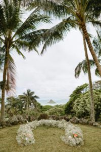 Decorative Floral Arrangement by Tropical Moon Event surrounded by coconut trees and the ocean at Kualoa Ranch