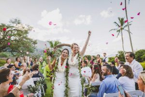 Newlywed Brides Walking Down the Aisle being celebrated by family and friends captured by Vivid Fotos