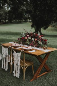 Bride and Groom's wooden table and chairs decorated with flowers at a Hawaii Wedding by Forrest Lauren