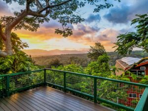 Hawaii Vista Lanai overlooking tropical trees during sunset
