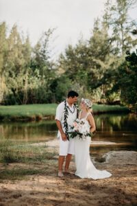 Bride and Groom smiling and looking into each others eyes surrounded by nature at Hawaii Polo Club