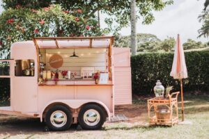 A Pink Mobile Bar Set up in a Tropical Garden for Gazoz Craft & Cocktails Mocktails