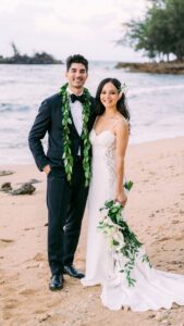 A Bride and Groom Smiling on a beach in Loulu Palms
