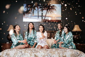 Bride and her bridesmaids celebrating in their bridal robes before the wedding festivities, captured by HNL studios