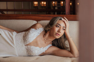 A bride laying down and posing for the camera on her special day