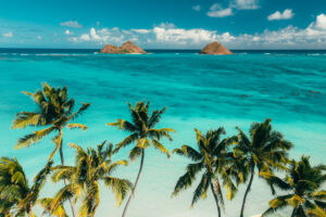 Beautiful Lanikai beach with clear blue waters and a view of the mokes shot by Aloha films