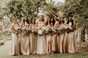 Bride and her Bridesmaids holding bouquets of flowers at a Tropical Garden in Hawaii