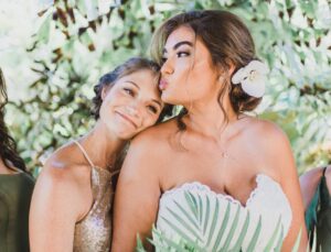 A bride and her bridesmaid showcasing their beauty and the artistry of the makeup application by Perfectly Made Hawaii