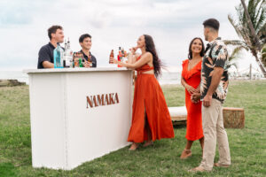 Wedding guests in front of Namaka Bar in an oceanfront setting